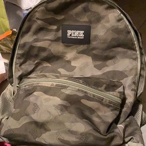 Pink backpack with two big pockets and small front pocket. Water bottle pockets.